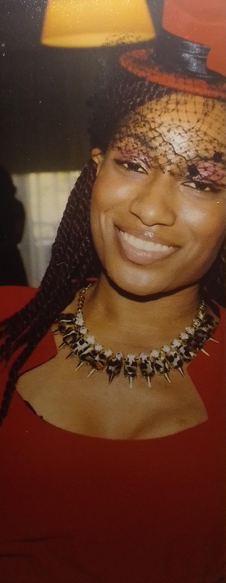 Sunni LaVasiette smiling in her red event ensemble