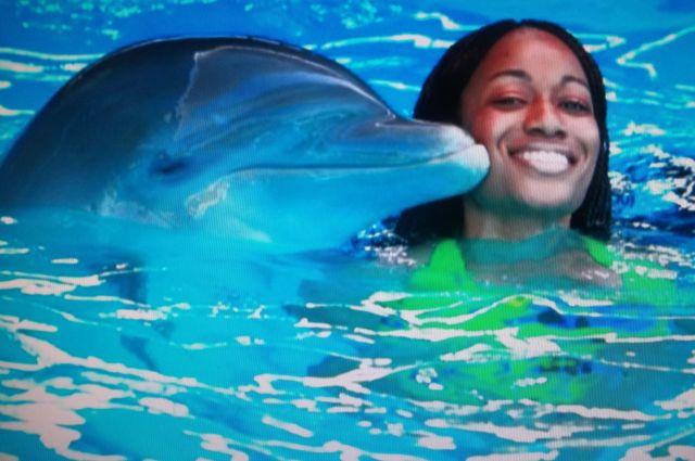 Sunni swimming with a dolphin